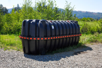 a large black plastic tank with two holes
